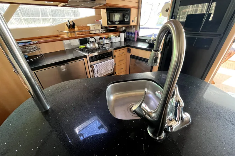  Yacht Photos Pics Luxurious kitchen interior of 2009 Kelsall 58 KSS yacht with modern appliances.