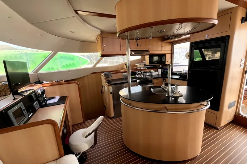  Yacht Photos Pics Luxurious 2009 Kelsall 58 KSS yacht interior with modern kitchen and navigation area.