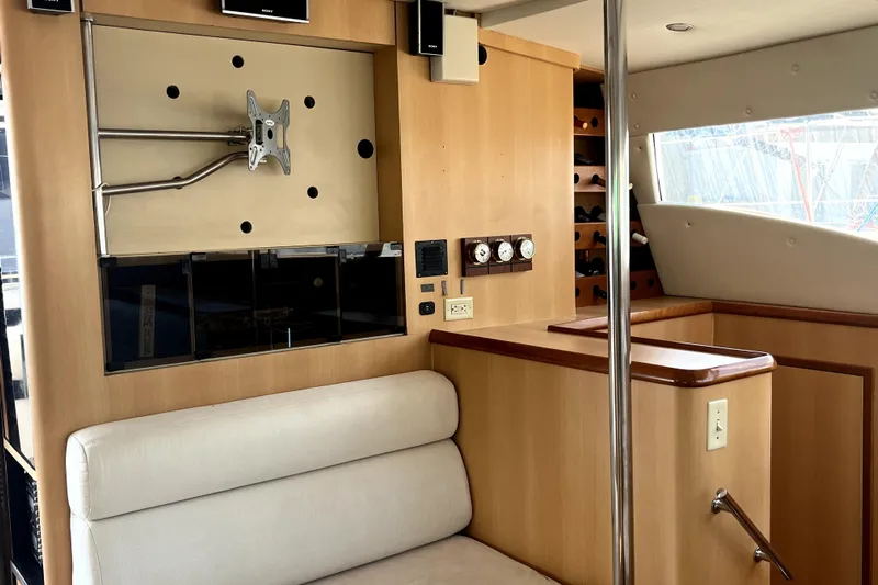  Yacht Photos Pics Interior of 2009 Kelsall 58 KSS yacht with seating, TV mount, and control panel.