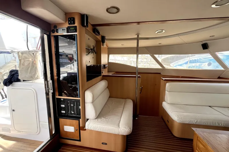  Yacht Photos Pics Interior of 2009 Kelsall 58 KSS yacht with white seating and wooden accents.