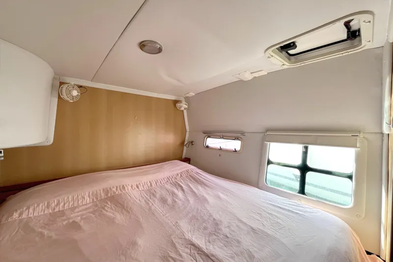  Yacht Photos Pics Cozy cabin interior of 2009 Kelsall 58 KSS with bed and windows.