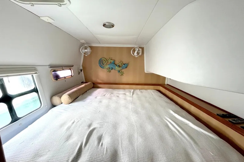  Yacht Photos Pics Cozy cabin bedroom in 2009 Kelsall 58 KSS yacht with decorative wall art.