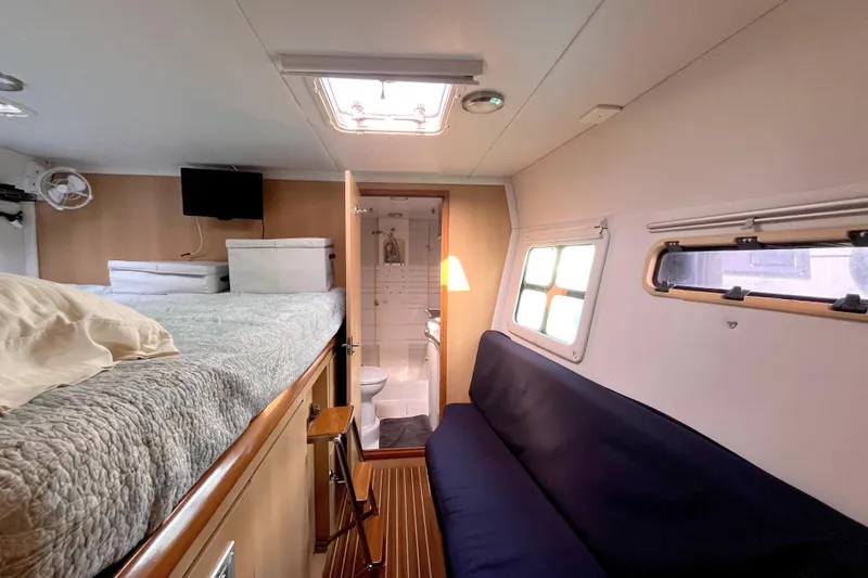  Yacht Photos Pics Interior of 2009 Kelsall 58 KSS yacht with bed, sofa, and bathroom.