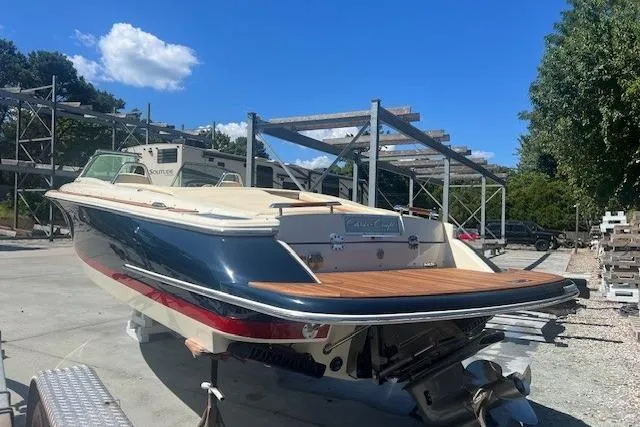  Yacht Photos Pics 2024 Chris-Craft Launch 27 boat with sleek design, docked outdoors under blue sky.