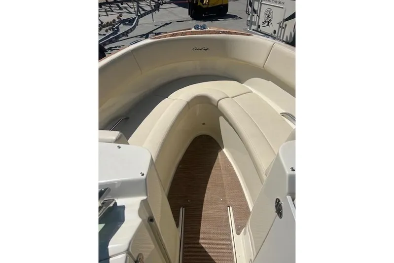  Yacht Photos Pics 2024 Chris-Craft Launch 27 boat interior with beige seating and wooden flooring.