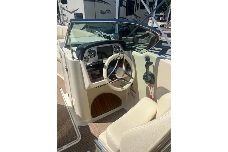  Yacht Photos Pics 2024 Chris-Craft Launch 27 boat cockpit with steering wheel and control panel.