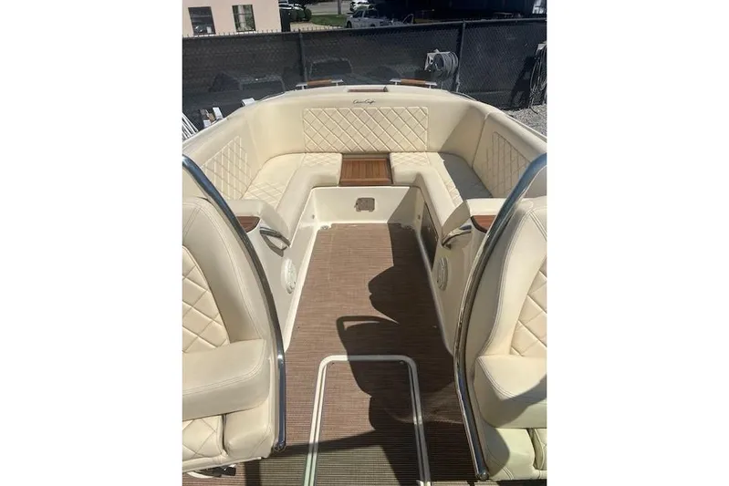  Yacht Photos Pics 2024 Chris-Craft Launch 27 boat interior with beige seating and wood accents.