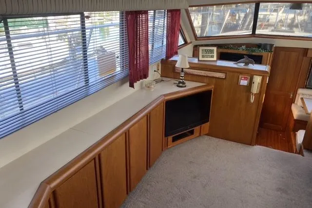 Gloryb2god Yacht Photos Pics Interior of 1990 Carver 55 yacht with wood paneling and large windows.