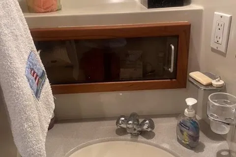 Gloryb2god Yacht Photos Pics Bathroom sink area in a 1990 Carver 55 yacht with towel and soap dispenser.