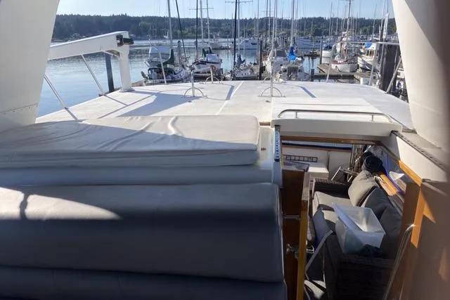 Gloryb2god Yacht Photos Pics 1990 Carver 55 yacht interior with marina view, featuring cushioned seating and open deck.