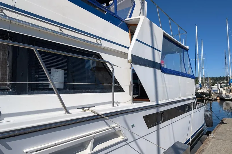 Gloryb2god Yacht Photos Pics 1990 Carver 55 yacht docked at marina, featuring sleek white and blue design.