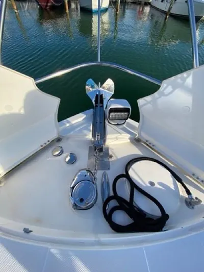  Yacht Photos Pics 2009 Meridian 391 Sedan yacht bow with anchor and rope, docked in marina.