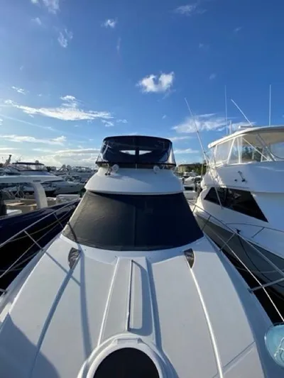  Yacht Photos Pics 2009 Meridian 391 Sedan yacht docked under a clear blue sky.