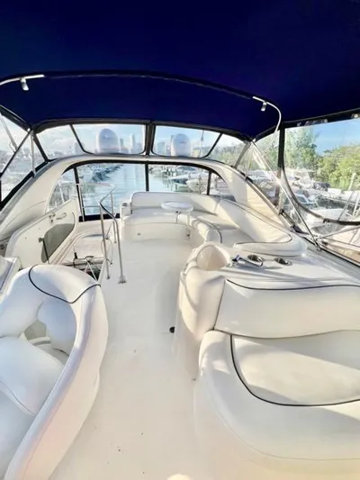  Yacht Photos Pics Interior view of 2009 Meridian 391 Sedan yacht with white seating and blue canopy.