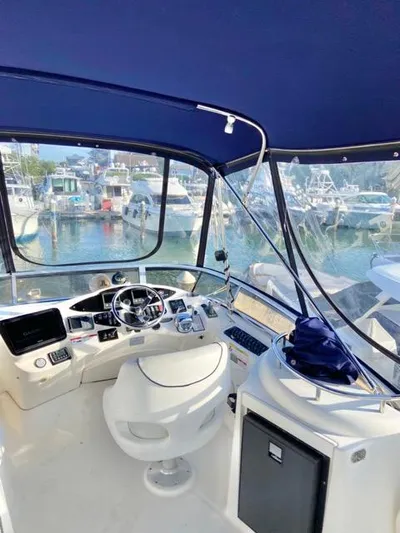  Yacht Photos Pics 2009 Meridian 391 Sedan yacht cockpit with marina view, featuring modern navigation equipment.