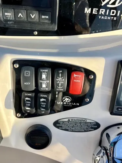  Yacht Photos Pics Control panel of a 2009 Meridian 391 Sedan yacht with various switches and buttons.