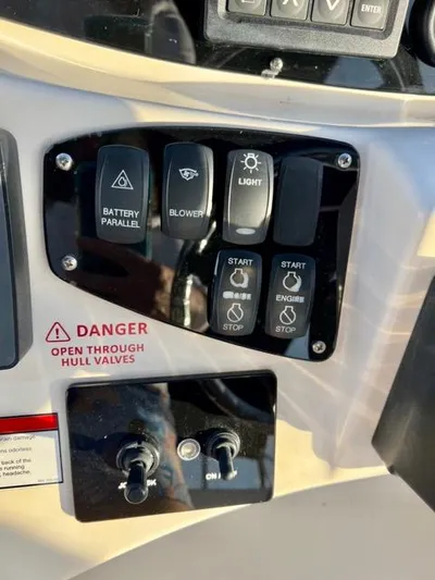  Yacht Photos Pics Control panel of a 2009 Meridian 391 Sedan boat with various switches and warning labels.