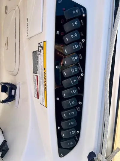  Yacht Photos Pics Control panel of a 2009 Meridian 391 Sedan boat with labeled switches and warning label.