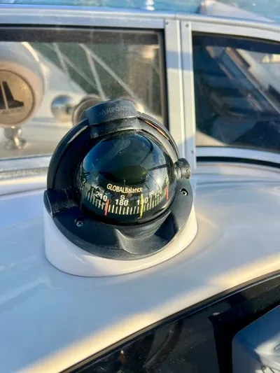  Yacht Photos Pics Compass on 2009 Meridian 391 Sedan boat dashboard, reflecting sunlight.