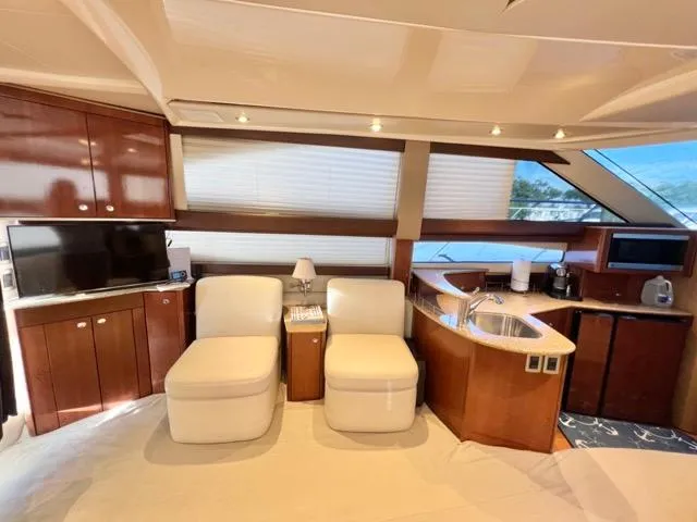  Yacht Photos Pics Luxurious interior of 2009 Meridian 391 Sedan yacht with modern furnishings and kitchen area.