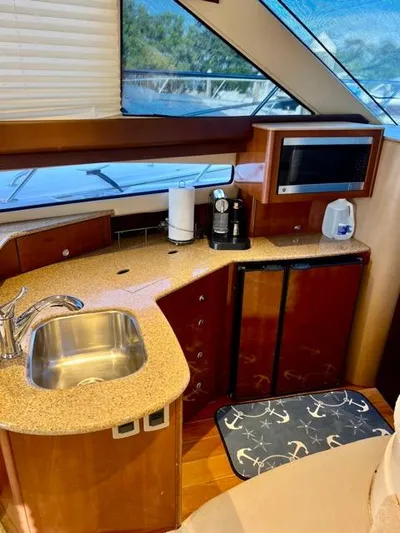  Yacht Photos Pics 2009 Meridian 391 Sedan yacht kitchen with sink, microwave, and coffee maker.