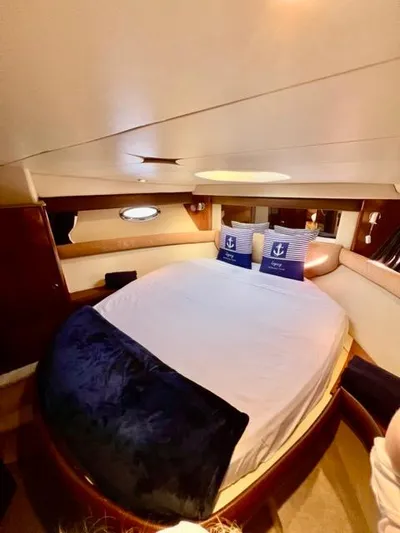  Yacht Photos Pics Luxurious 2009 Meridian 391 Sedan yacht bedroom with cozy bedding and nautical decor.