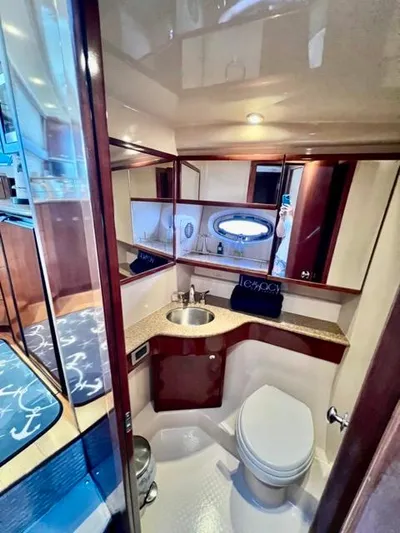  Yacht Photos Pics Luxurious bathroom in 2009 Meridian 391 Sedan yacht with modern fixtures and wood accents.