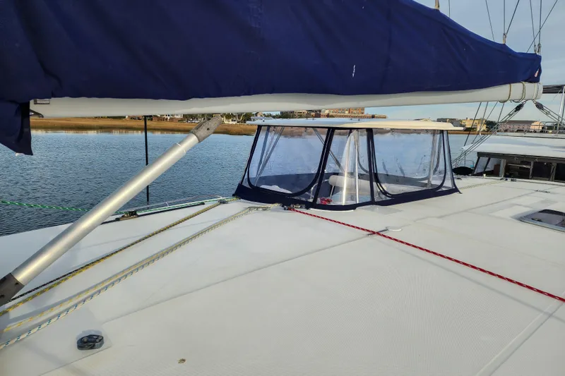 Playtime Yacht Photos Pics 2016 Leopard 44 Owners Version catamaran deck with blue canopy and clear enclosure.