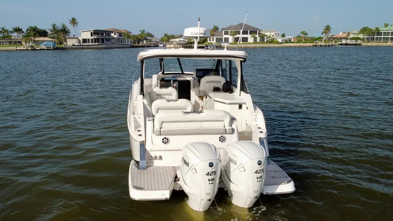 C Life Yacht Photos Pics 2021 Regal 36 XO boat with twin Yamaha 425 engines on a calm waterway.