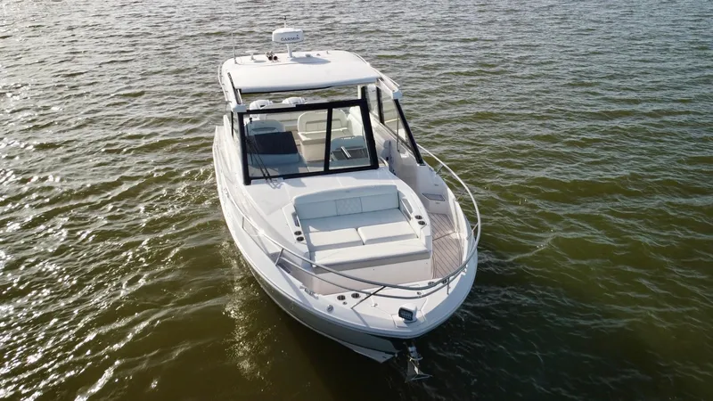 C Life Yacht Photos Pics 2021 Regal 36 XO boat on calm water, aerial view.