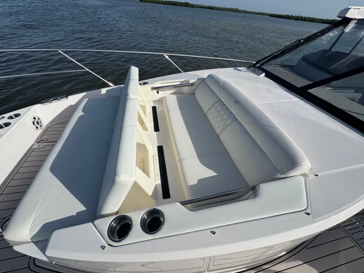 C Life Yacht Photos Pics 2021 Regal 36 XO boat with spacious white seating on deck, overlooking calm waters.