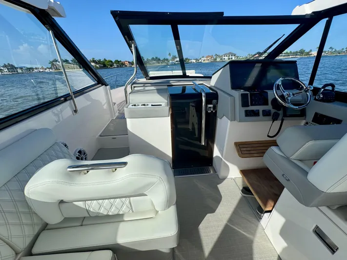 C Life Yacht Photos Pics 2021 Regal 36 XO boat interior with luxurious seating and modern helm.