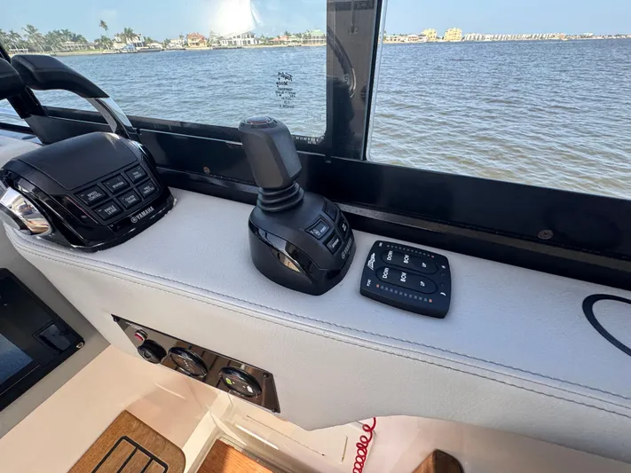 C Life Yacht Photos Pics Control panel of 2021 Regal 36 XO boat with scenic water view.