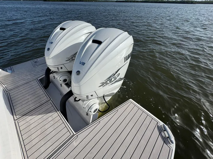 C Life Yacht Photos Pics Twin Yamaha outboard engines on a 2021 Regal 36 XO boat, docked on calm water.