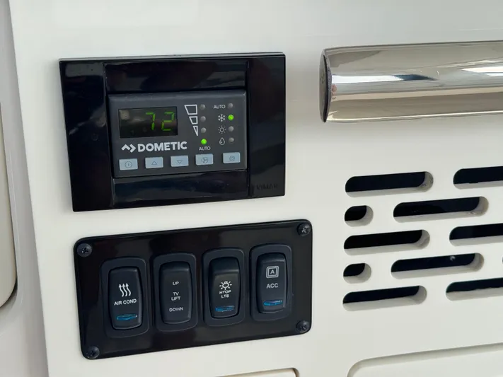 C Life Yacht Photos Pics Control panel of a 2021 Regal 36 XO boat with Dometic thermostat and switches.