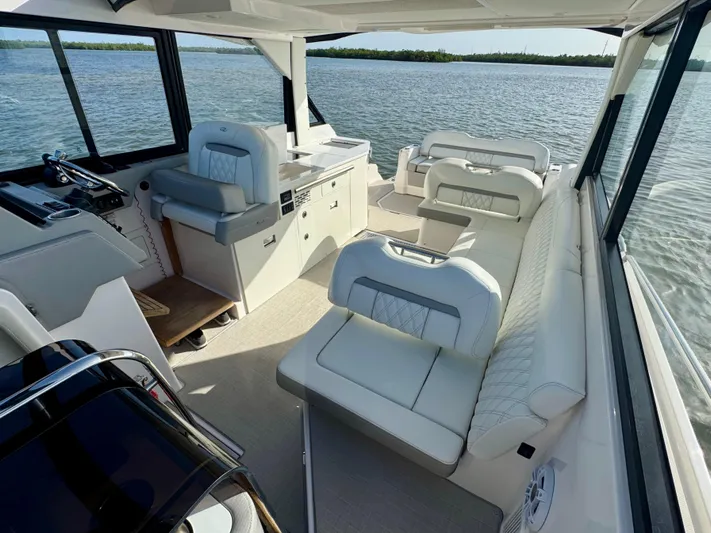 C Life Yacht Photos Pics 2021 Regal 36 XO boat interior with luxurious white seating and scenic water view.