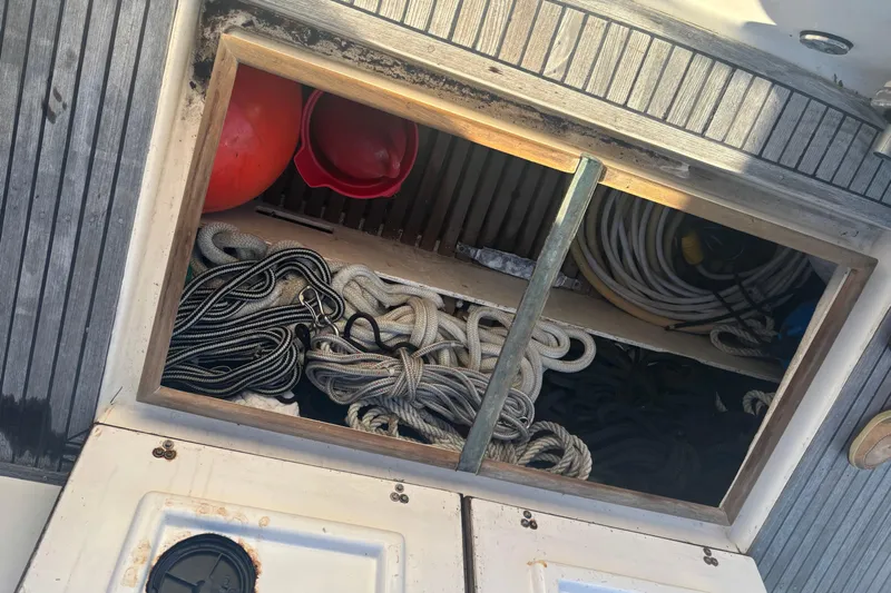 Maximon Yacht Photos Pics Storage compartment on 1989 Grand Banks 46 Classic boat with ropes and equipment.