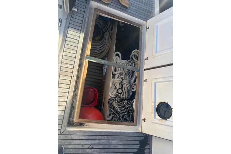 Maximon Yacht Photos Pics Storage compartment on 1989 Grand Banks 46 Classic boat, containing ropes and equipment.