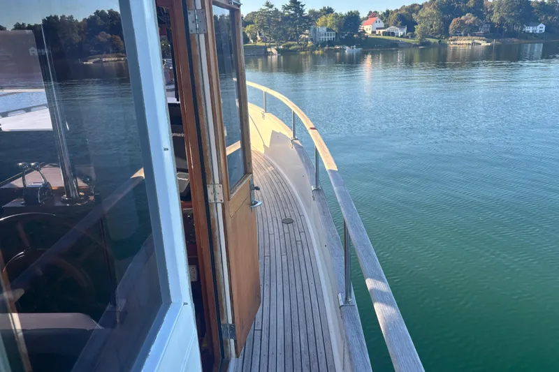 Maximon Yacht Photos Pics 1989 Grand Banks 46 Classic yacht on calm water, showcasing wooden deck and serene surroundings.