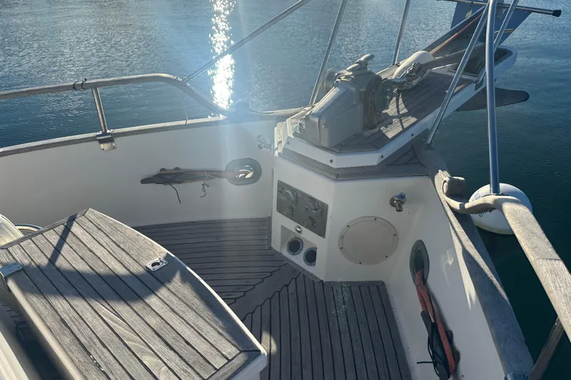 Maximon Yacht Photos Pics 1989 Grand Banks 46 Classic yacht deck with wooden finish and water reflection.