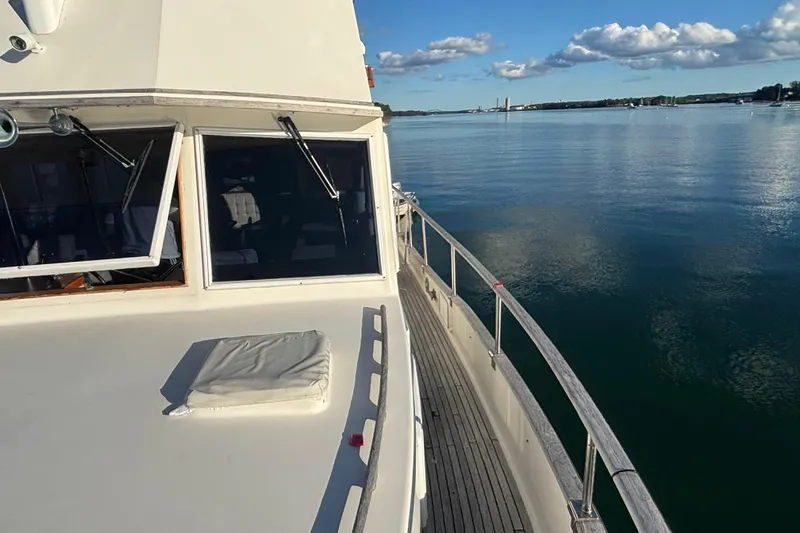 Maximon Yacht Photos Pics 1989 Grand Banks 46 Classic yacht on calm water under a clear blue sky.