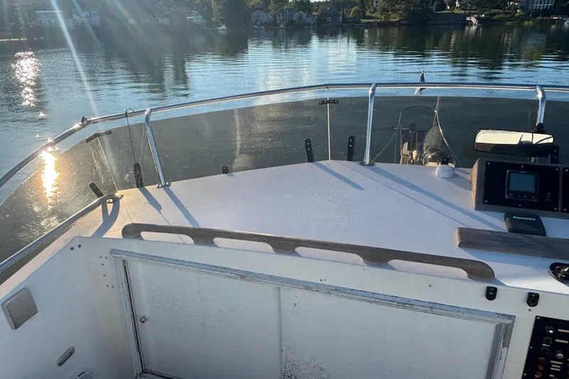 Maximon Yacht Photos Pics 1989 Grand Banks 46 Classic yacht deck with serene water view and sunlight reflections.