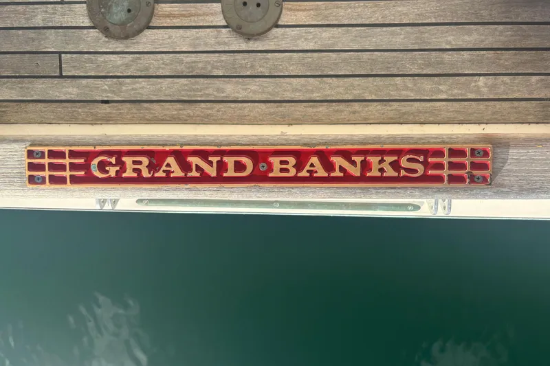 Maximon Yacht Photos Pics Grand Banks 46 Classic 1989 boat nameplate on wooden deck.