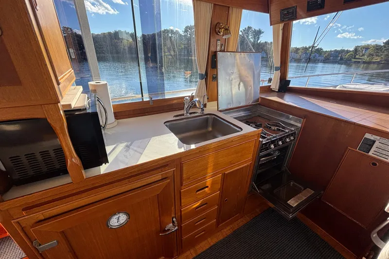 Maximon Yacht Photos Pics Interior of 1989 Grand Banks 46 Classic yacht with kitchen and scenic water view.