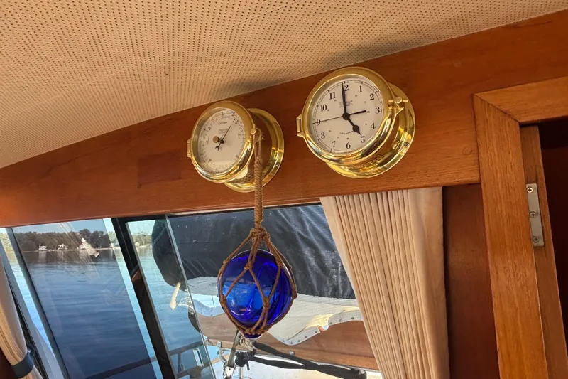 Maximon Yacht Photos Pics Interior of 1989 Grand Banks 46 Classic with brass clock, barometer, and nautical decor.