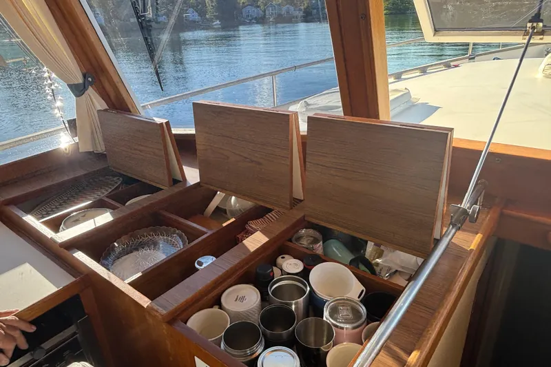 Maximon Yacht Photos Pics Interior of 1989 Grand Banks 46 Classic yacht with open wooden storage compartments.