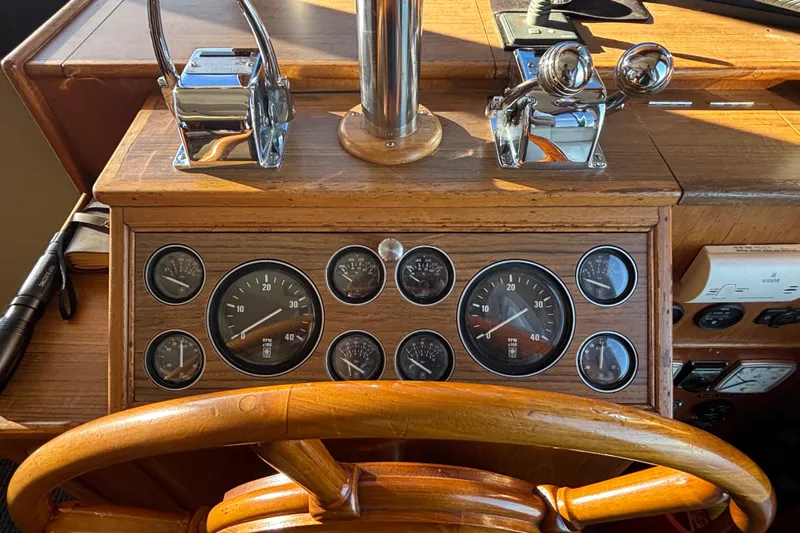Maximon Yacht Photos Pics 1989 Grand Banks 46 Classic helm with wooden wheel and vintage gauges.