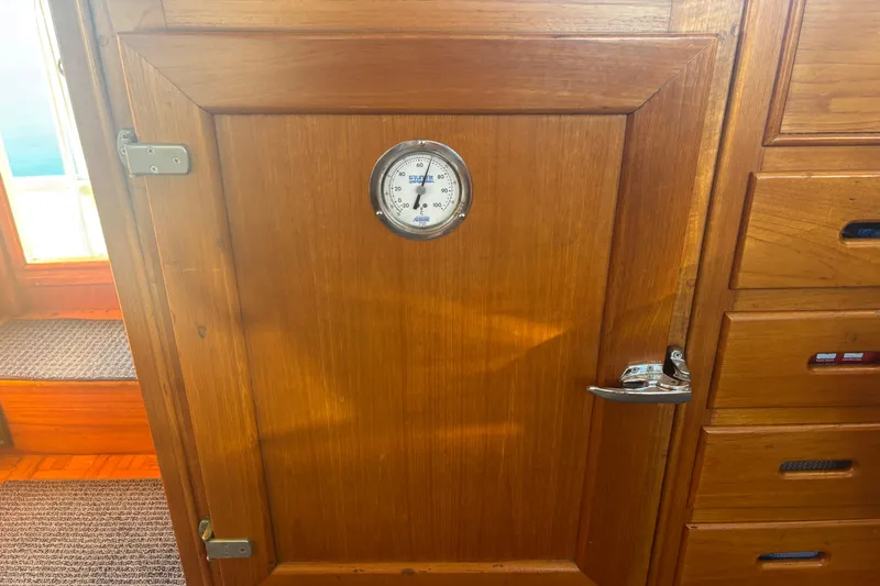 Maximon Yacht Photos Pics Wooden interior of 1989 Grand Banks 46 Classic with thermometer on cabinet door.