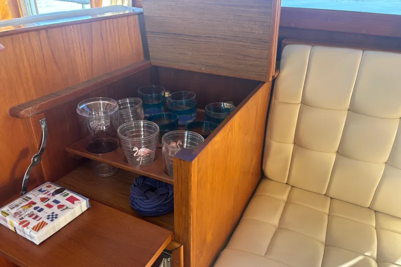 Maximon Yacht Photos Pics Wooden cabinet with glassware and napkins on a 1989 Grand Banks 46 Classic yacht.
