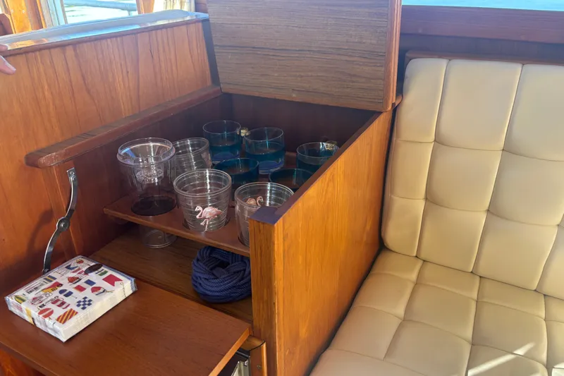 Maximon Yacht Photos Pics Interior of 1989 Grand Banks 46 Classic with wooden cabinet and glassware storage.